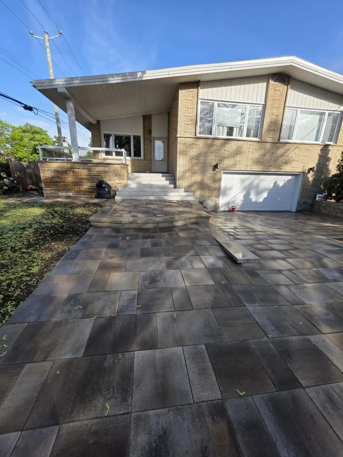 Bungalow with a new large-format paver driveway and stepped entry