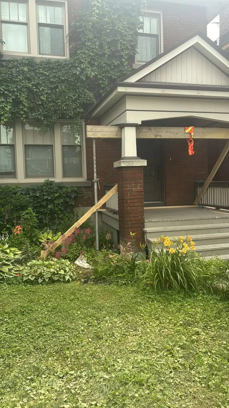 Front porch with brick columns and steps before works