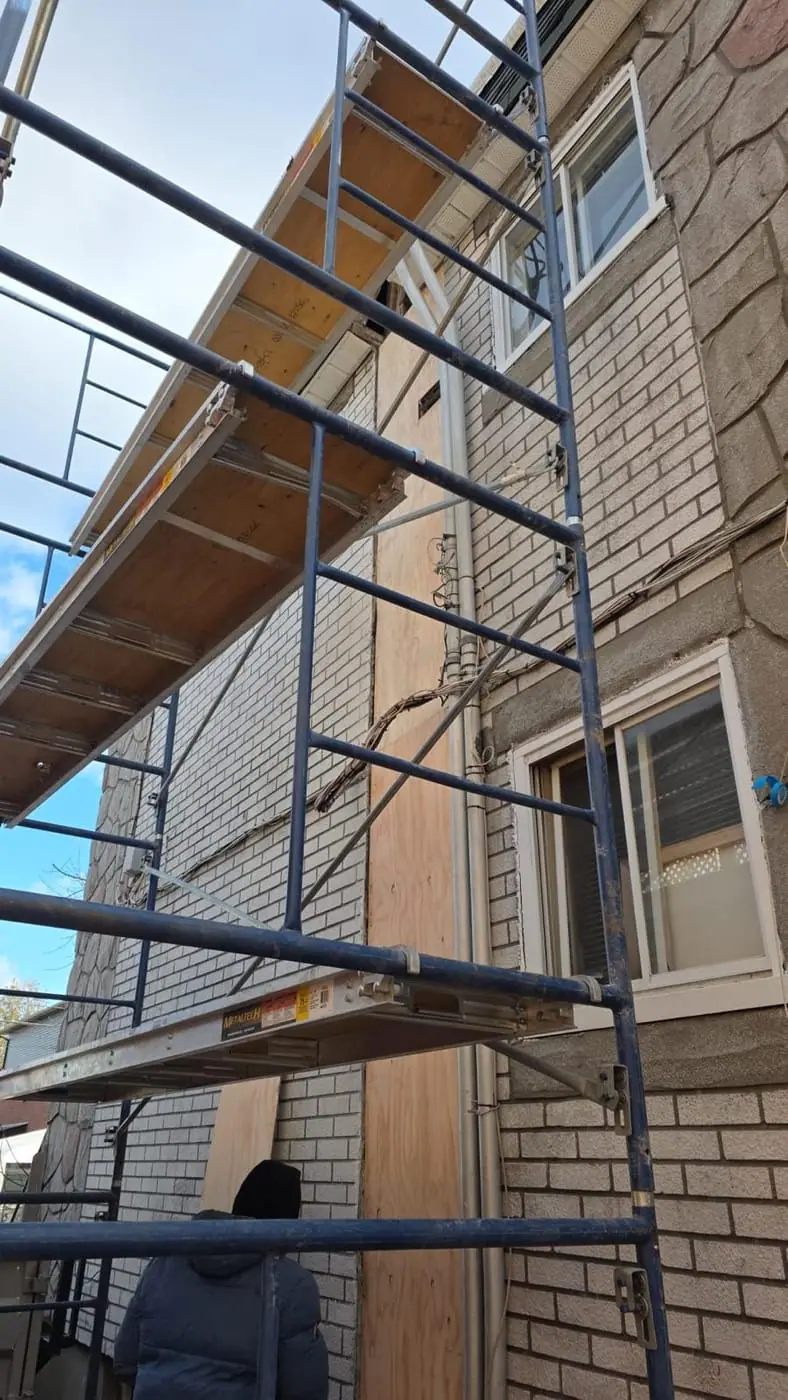 Scaffolding in place for façade works on a stone and brick house