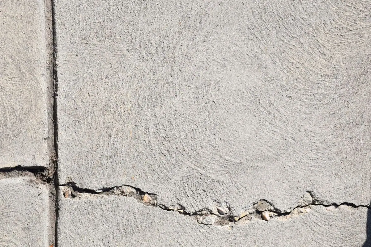 Close-up of a crack running along a joint in a concrete wall